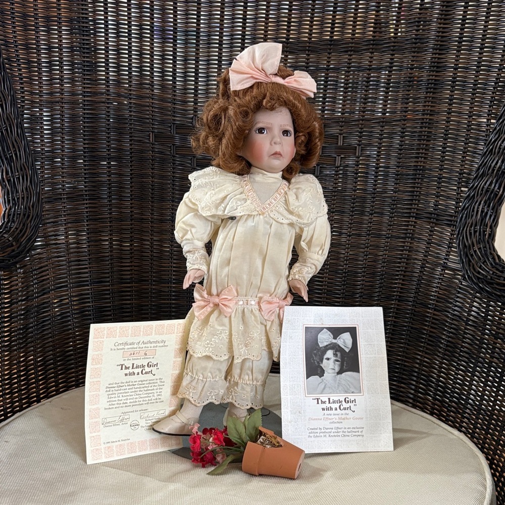 Porcelain Doll with Pink Dress and Bow. Certificate of authenticity and stand